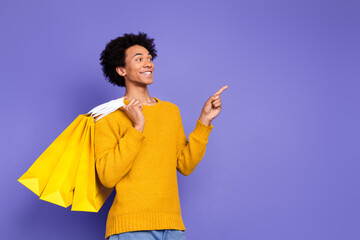 Sticker - Photo of handsome positive man wear trendy yellow clothes look empty space isolated on purple color background