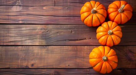 Canvas Print - Orange pumpkins on a wooden table, copy space, top view.