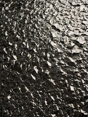 Aufkleber - Image showcases close-up view of textured surface, likely metallic, with crumpled, uneven appearance. Surface reflects light in various directions, creating play of shadows.