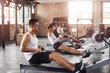 © peopleimages.com - Fitness, gym and people on rowing machine for health, wellness and body workout with class. Endurance, exercise and group of athletes on ergometer equipment for cardio cross training in sports center