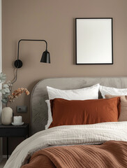 Wall Mural - A bedroom wall with an empty picture frame hanging on it, with warm and neutral tones of brown, beige, white, and grey creating a cozy atmosphere. The room features comfortable bed linens.