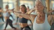 © Iuliia Metkalova - Yoga class in the warrior pose. Students are women of mixed ages. Seniors doing yoga pilates exercises outdoor, gym in background. Healthy lifestyle and joyful elderly concept. Generative ai