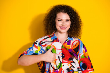 Wall Mural - Photo portrait of lovely young lady thumb up dressed stylish colorful print garment isolated on yellow color background