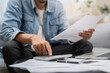 © Pormezz - Household financial economic concept, Stressed Young Asian adults are looking at credit card bills issued documents, and apartment loan mortgages and worrying about having no money to pay.