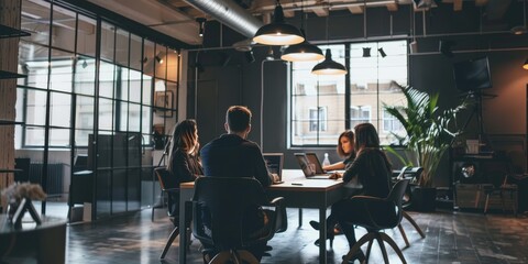 Canvas Print - A group of people are sitting around a table in a conference room