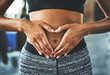 © ClearConcept/peopleimages.com - Health, digestion and hands on stomach for woman in gym, nutrition and gut support detox. Wellness, fibre and female person, diet and balance fitness lifestyle for belly weight loss and core exercise