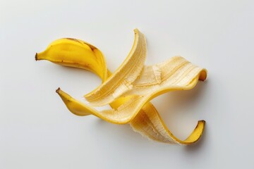 Poster - A single yellow banana without its peel sitting on a white surface, ideal for food or health-related concepts