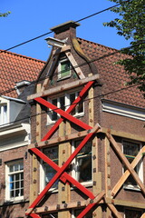 Wall Mural - Amsterdam Rozengracht Building Facade with Red Supporting Beams, Netherlands