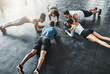 © peopleimages.com - People, training and plank in group at gym for workout, core exercise or fitness together indoors. Diverse class, friends and warm up for ab muscle, session and sport for health on gymnasium floor