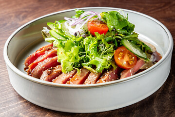 Wall Mural - Seared tuna with fresh greens, sesame seeds, and tangy dressing