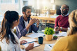 © peopleimages.com - Man, business people and startup with paperwork in discussion, meeting and planning in modern office. Teamwork, documents and diversity with conversation, problem solving and group at creative agency