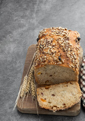 Sliced wholemeal rye bread with pearl barley on gray background