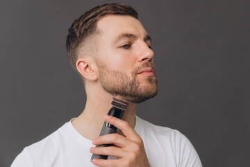 Beard hair trimmer, portrait or happy man with bathroom routine, grooming for shaving skincare. Face cleaning, facial growth maintenance or studio person happiness on gray background