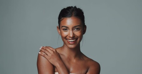 Wall Mural - Face, makeup and skincare of happy Indian woman in studio isolated on gray background. Portrait, touch and beauty of young model for facial cosmetics, dermatology or laughing for healthy glow at spa