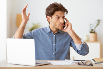 Aufkleber - A man sits at a desk, working on a laptop and talking on his phone. He looks frustrated and appears to be arguing with someone on the other end of the call.