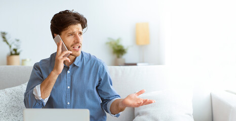 Aufkleber - A frustrated young man talks on the phone with a stressed look on his face while sitting on a couch. He appears to be arguing or having a difficult conversation.