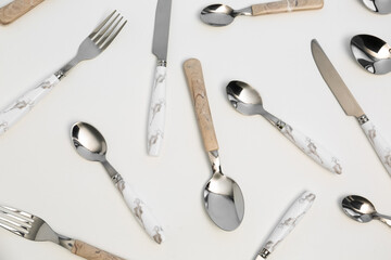 Wall Mural - Set of stainless steel cutlery with plastic handles on white background