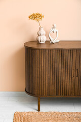 Poster - Vase with dried hydrangea and figurine on dresser near beige wall