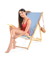 Poster - Beautiful young woman applying sunscreen cream in deck chair on white background