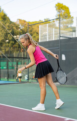 Wall Mural - Tennis game - girl getting ready to hit the ball with racket. High quality photo