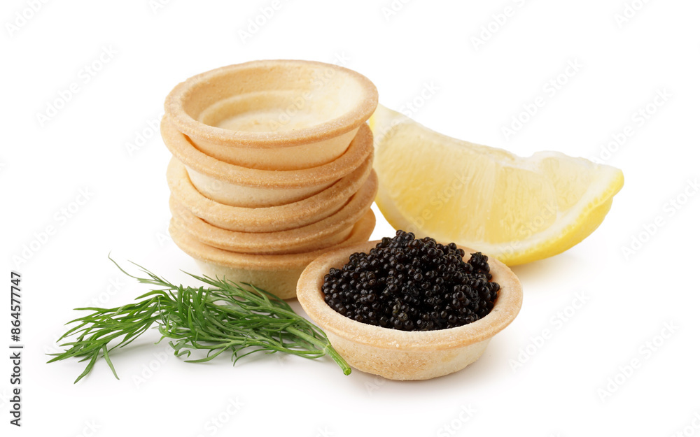 Tasty tartlets with black caviar and lemon on white background