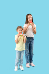 Canvas Print - Little girls with slices of fresh watermelon on blue background