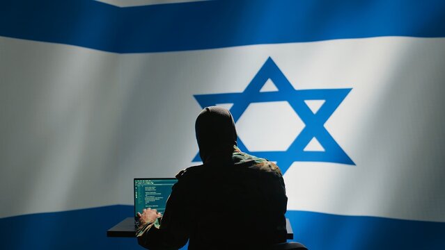 Israel secret police agent uses mass propaganda tools on laptop to influence population minds, engaging in psychological operations. Mossad Israeli spy commits PsyOp sabotage using device, camera B