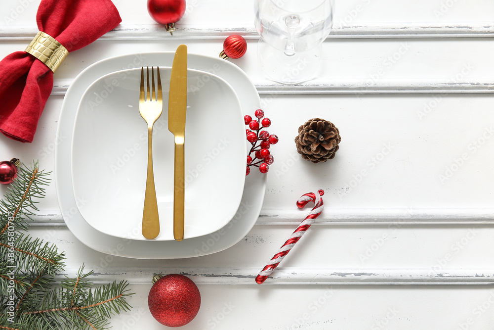 Festive table setting with Christmas decorations on white wooden table
