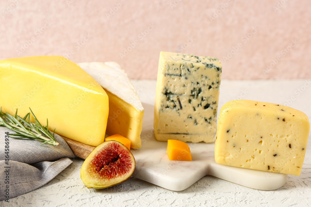 Board with tasty cheese on white background