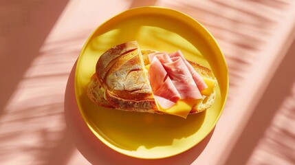 Wall Mural - A tasty ham and cheese sandwich on a yellow plate