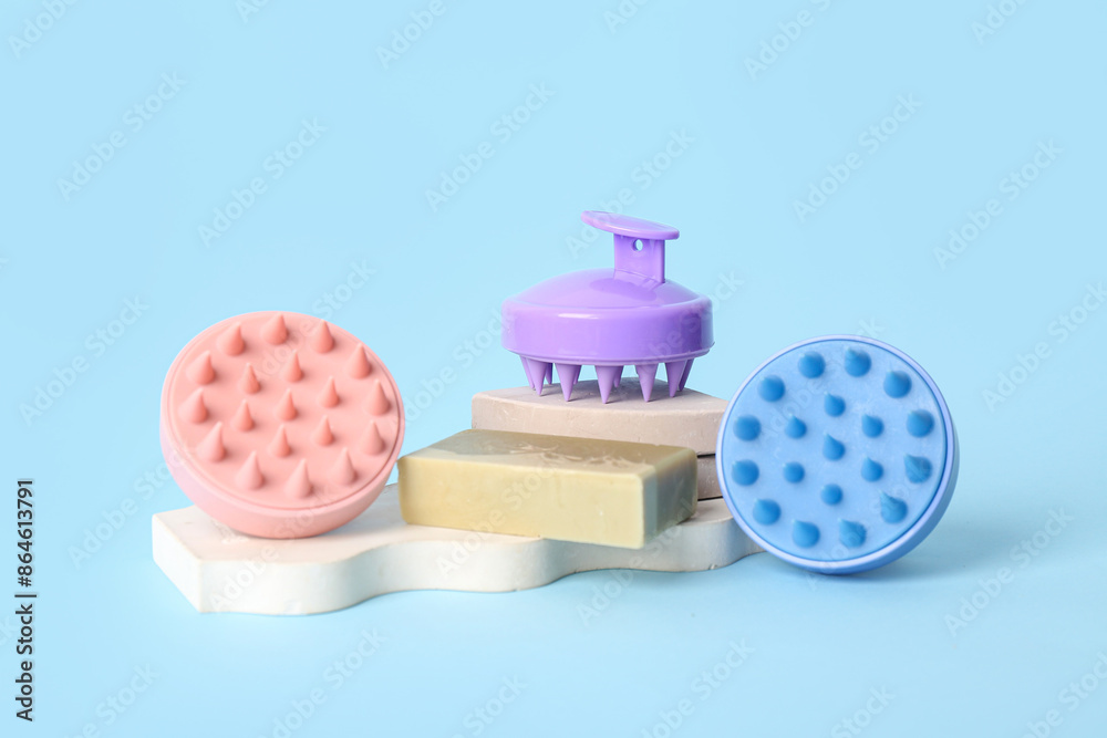 Hair scalp massagers with shampoo bar and stands on blue background