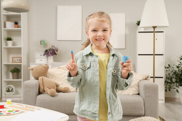 Sticker - Cute little girl with paint at home