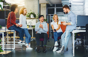 Poster - Creative team having discussion on new design project in office, informal friendly atmosphere at work
