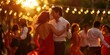 © Brian - Young couple dances under glowing lights as the sun sets on a celebration party