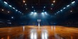 © SkoldPanda - An empty basketball court glowing with spotlights, ready for the game to start.