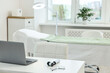 © New Africa - Modern interior of dermatologist's office with examination table