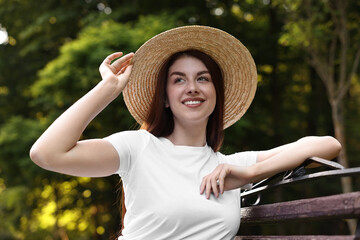 Wall Mural - Portrait of smiling woman in hat outdoors. Spring vibes