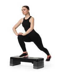 Canvas Print - Young woman doing aerobic exercise with step platform on white background