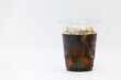 © two K - Iced Americano in a take-out plastic cup. white background