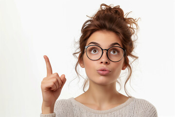 Canvas Print - A woman with glasses and a messy bun is pointing to her nose