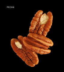 Wall Mural - Creative layout made of pecan nuts on the black background. Food concept. Macro concept.	