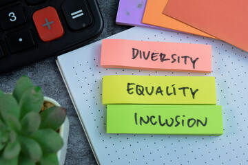 Concept of Diversity, Equality, Inclusion write on sticky notes isolated on Wooden Table.