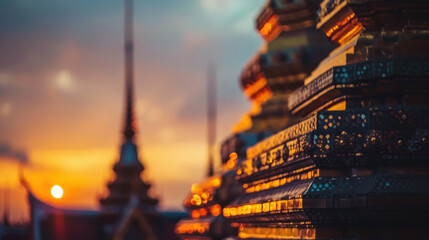 Close-up of ornate temple structures, stupa lit at sunset