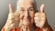 © Todd's Studio - Beautiful senior woman showing thumbs up with both hands, elderly care, positive life attitude of seniors