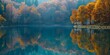 © Da - Reflection on the lake surface: The calm lake surface reflects an autumn scenery. The lake water is crystal clear and the reflection is clearly visible. Natural seasonal changes, generated by AI, high