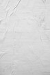 © wachiwit - Vertical white crumpled paper poster texture background