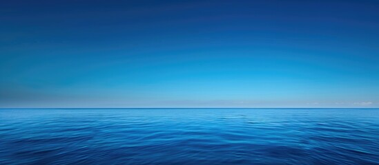 Wall Mural - Bright Blue Morning Sky and Deep Indigo Ocean: A Serene Visual Encounter