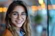 © Yuliia - Close-up of laughing businesswoman wearing eyeglasses talking to doctor via video chat.