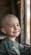 © Sasa Visual - A young boy with a shaved head smiles while looking out a window