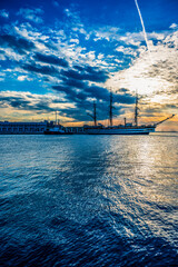 Wall Mural - Historic city of Trieste. Between ancient buildings and reflections on the sea. Autumn day and celebration of the Barcolana International Regatta.